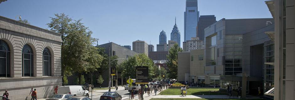 Campus looking down 17th Street with city skyline in the background