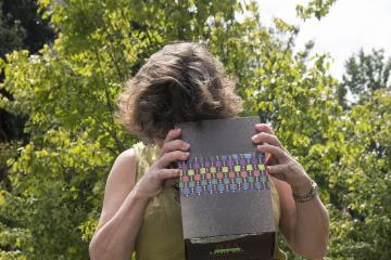 Faculty member views the eclipse through a homemade viewing box.