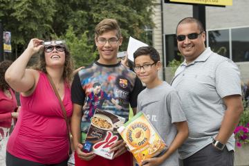 Staff member Angelica Aguirre and her family enjoy the eclipse party.