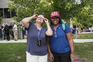 Two Eclipse Party Goers pose for the camera.