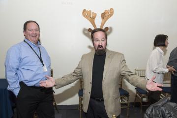 Faculty member Mark Kushner wears reindeer ears and smiles for the camera