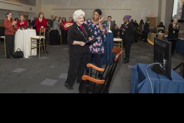 Kathryn Dutkiewicz receives her rocking chair for 50 years of service to the College