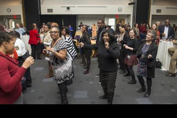 Attendees joining in a line dance