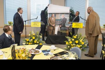 Patrick Clancy and Willie Johnson look on as Sulaiman Rahman and Dr. Generals reveal the magazine cover.