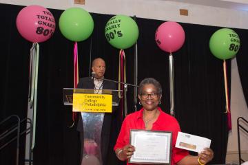 A staff member receives her certificate for 25 years of service.