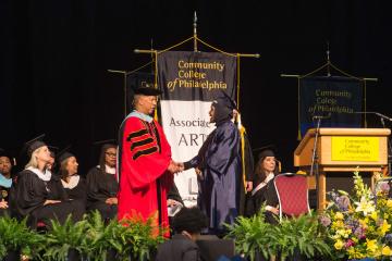 President Dr. Generals congratulates a graduate.