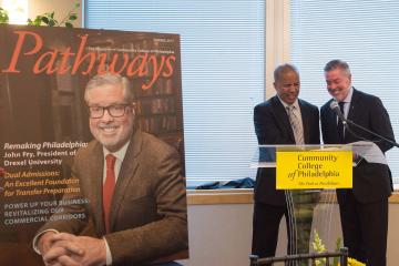 President Generals presents Drexel President Fry with his Pathways Magazine cover story.
