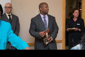 Pathways Magazine featured alum, Mckeithan Owens holds a copy of the magazine.