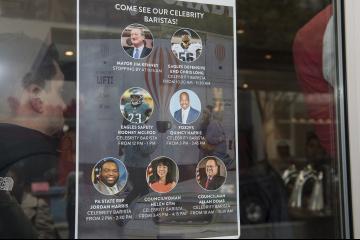 A window poster announces special guests of the event.