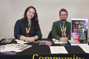Greeters Kerri Grogan and Aiden Kosciesza  welcome attendees to the LGBTQ conference.
