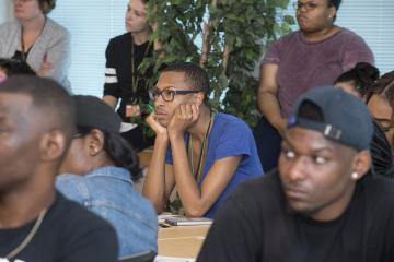 A conference participant listens to the presentation.