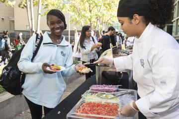 A happy student receives her Fiesta food.