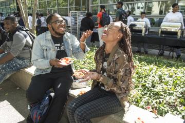 Students enjoy their meal and the sunshine.
