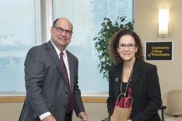 Director of Academic Success Initiatives, Sandra Gonzales-Torres accepts a gift of thanks from President Hawkinson.