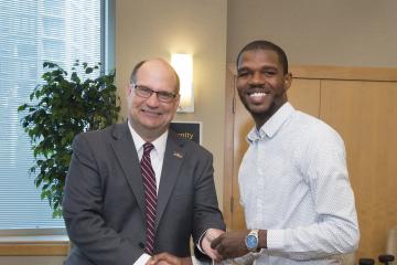Fred Dukes accepts a gift from President Hawkinson.