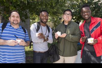 A group of fellows pose with their ice cream.