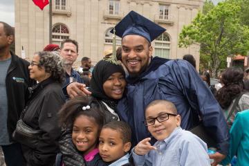 A graduate celebrates with his family after the ceremony.