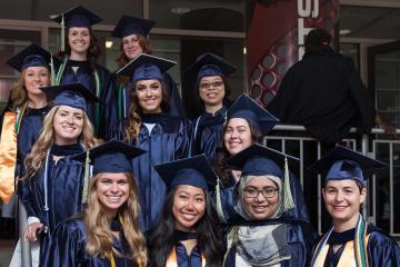 A group of graduates pose for the camera.