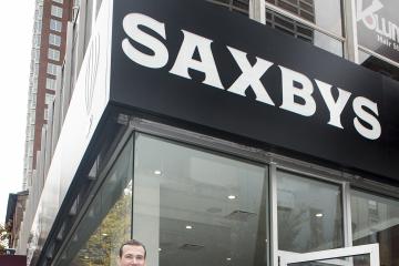 Dr. Generals and Nick Bayer, Saxbys CEO and College Foundation Member, pose outside the store.