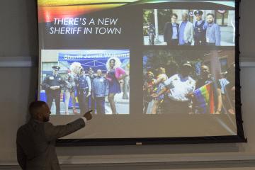 Mr. Austin shows the audience photographs from his work as the LGBT Liaison for the Philadelphia Office of the Sheriff.