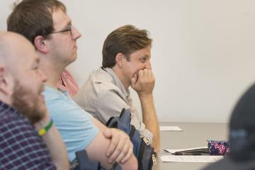 Faculty member Brian Goedde listens to fellow faculty member, Richard Keiser's workshop presentation
