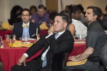Presenter Darryl Irizarry and the audience listens to the keynote speaker.